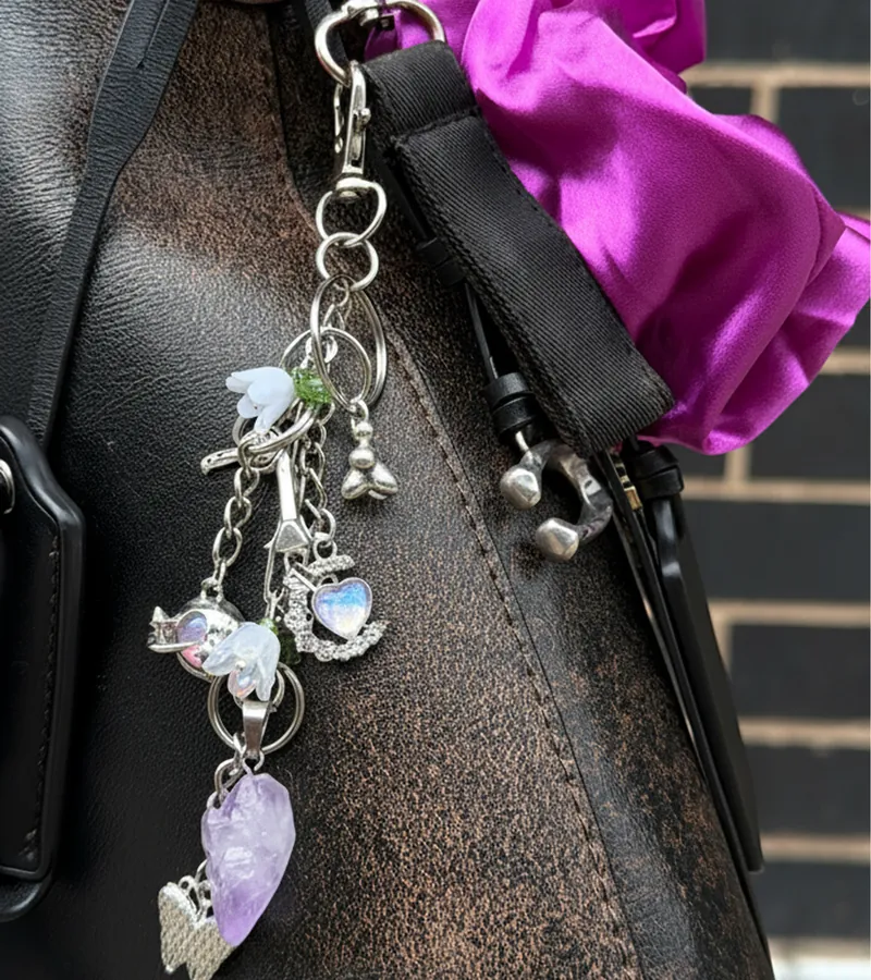 Braid charm keychain clipped to a leather bag