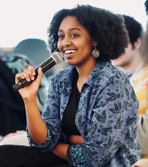 Panelist speaking into a microphone at a community event