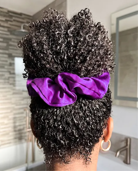 Purple satin Braid scrunchie worn in curly hair