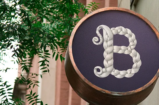 Round shop sign with the braided Braid “B” logo